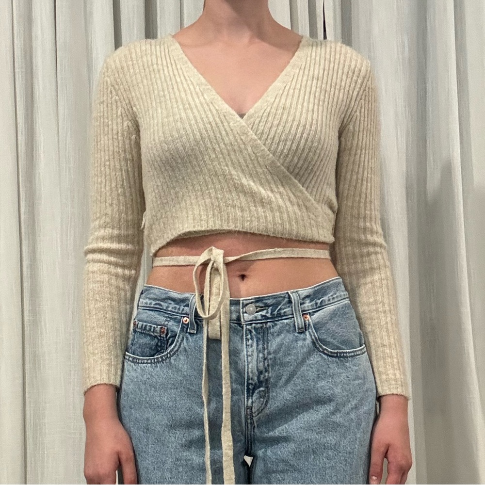 Urban outfitters beige wrap around cropped sweater.